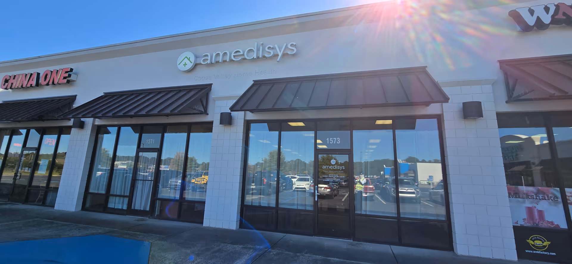 Exterior of a strip mall with Coosa Valley Home Health Care (an Amedisys Company) signage.