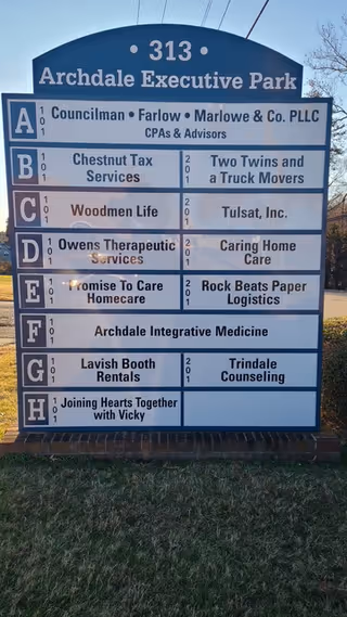 Outdoor directory sign listing tenants at Archdale Executive Park, including Promise To Care Homecare.