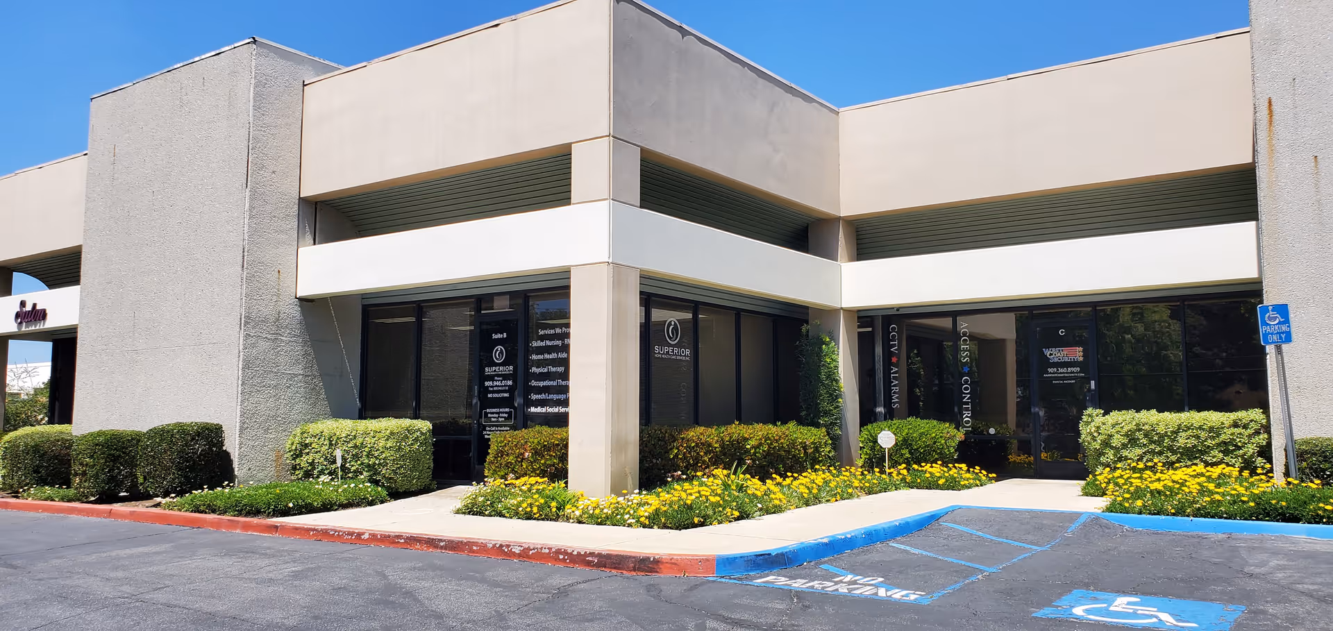 Exterior of Superior Home Health Care building with glass entrance, landscaping, and handicapped parking.