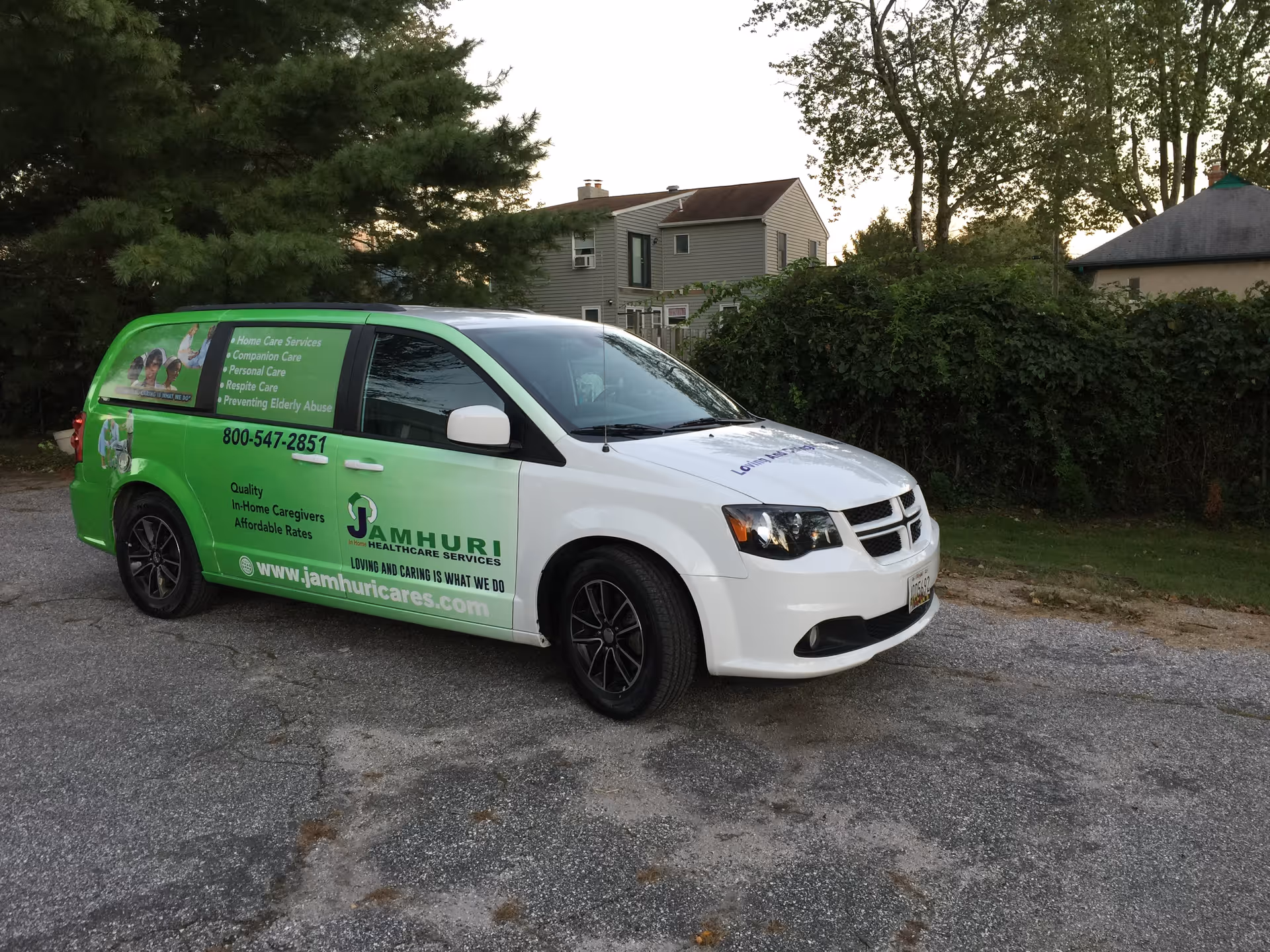 Green and white Jamhuri Healthcare Services van parked on a gravel driveway.