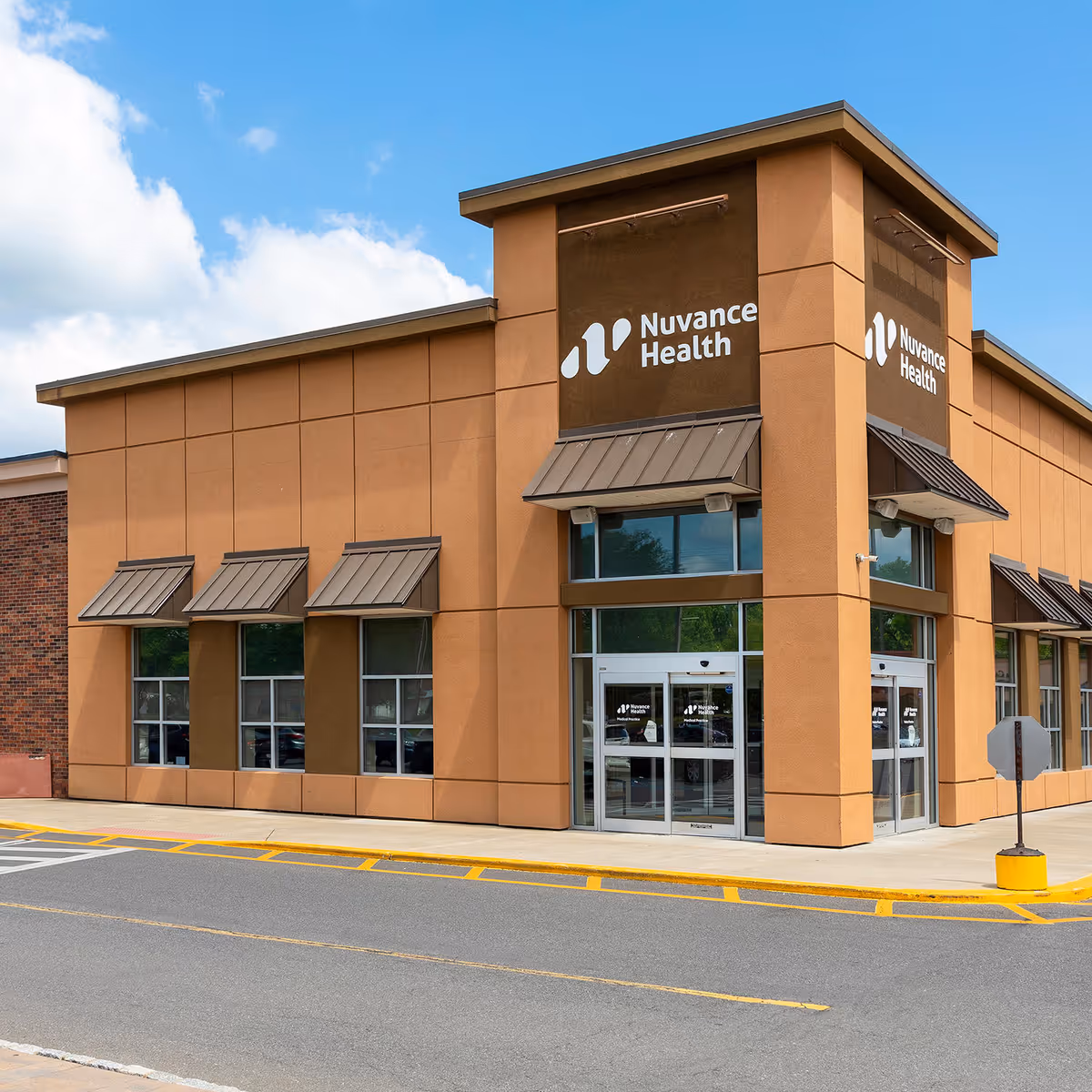 Exterior view of a Nuvance Health medical building with glass doors and prominent signage.