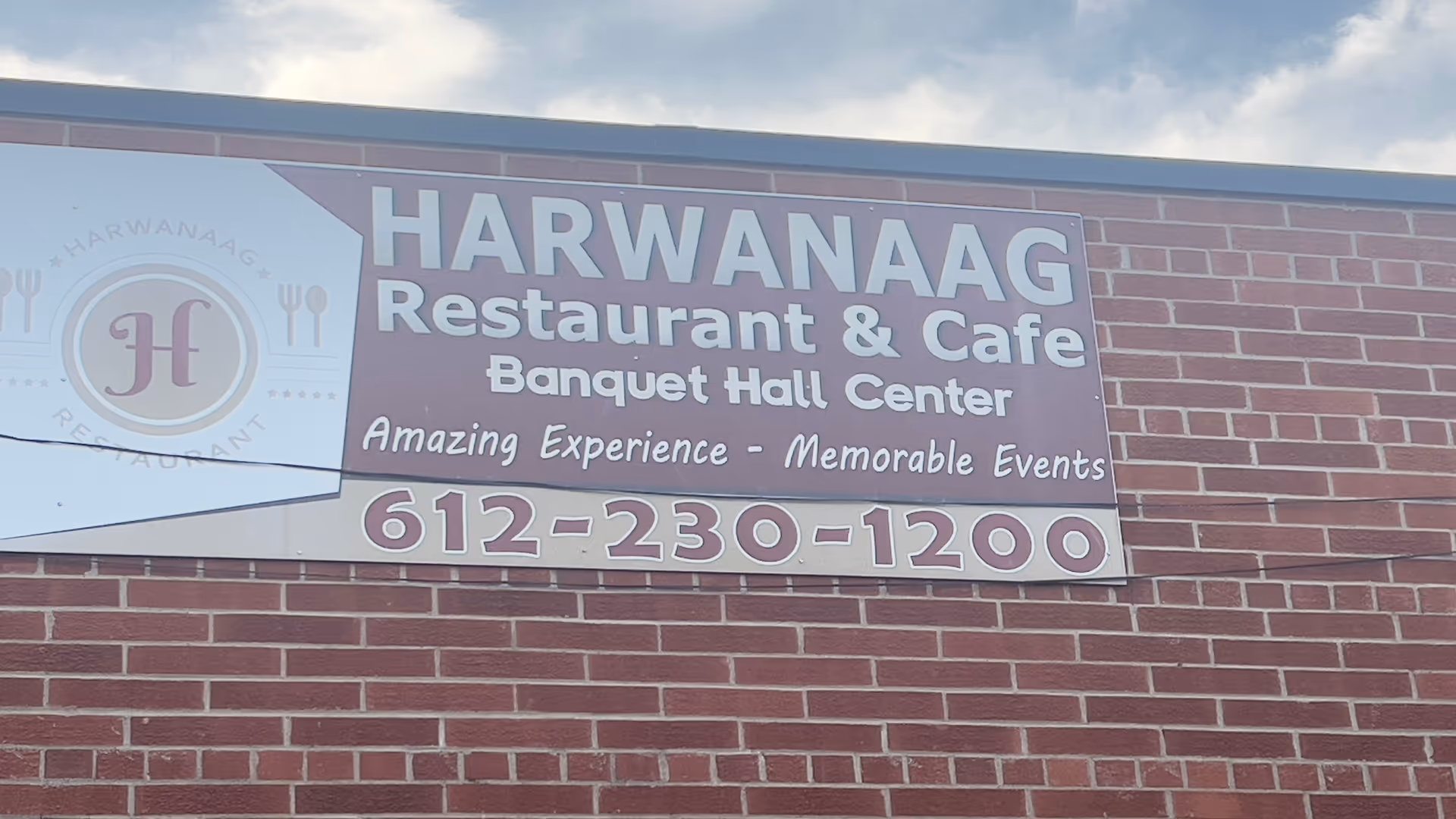 Brick building exterior with a large Harwanaag Restaurant & Cafe sign.