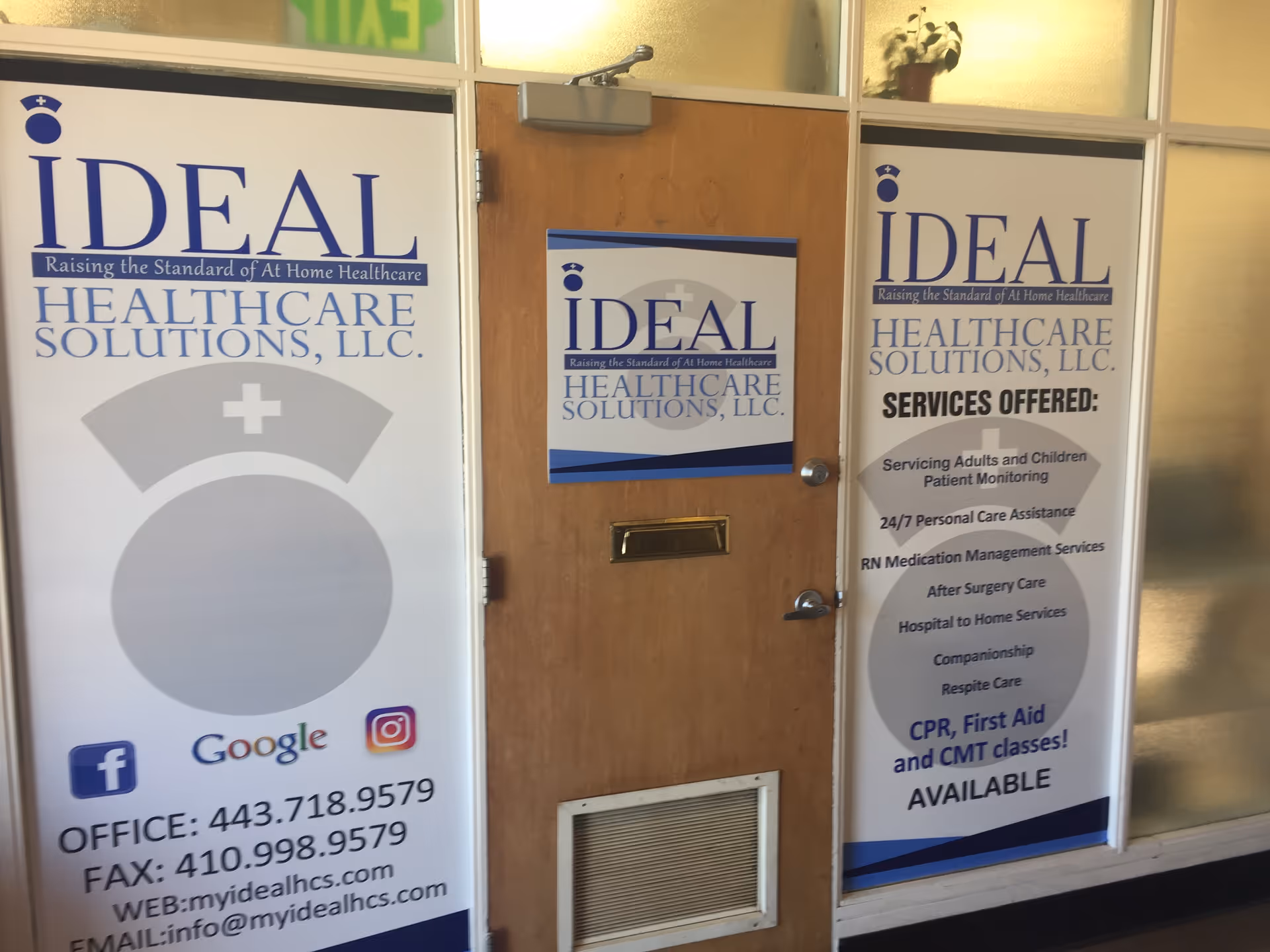 Glass storefront with three Ideal Healthcare Solutions, LLC signs and a wooden door.