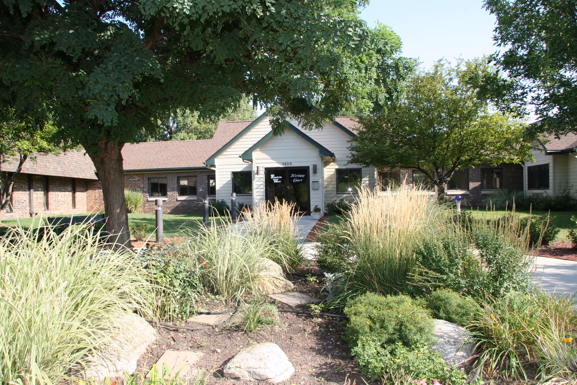 Front view of Pine Acres Rehabilitation and Care Center with a landscaped entrance and walkway.