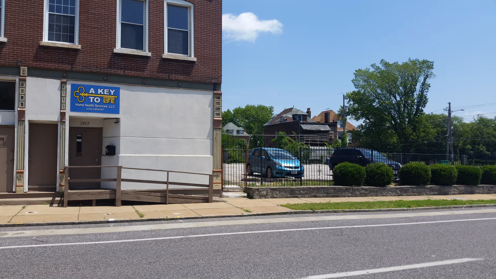Brick storefront shows A Key to Life Home Health Services LLC with fence and parking lot