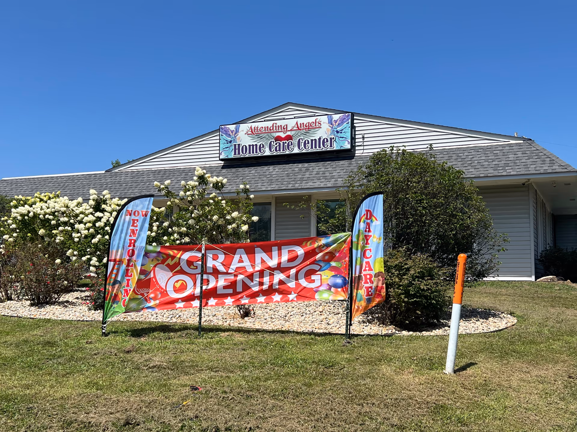 Front view of Attending Angels Home Care Center with grand opening banner.