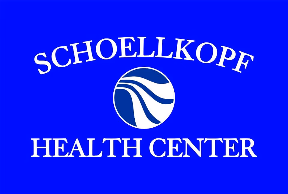 Bright blue sign displaying the Schoellkopf Health Center logo and text.