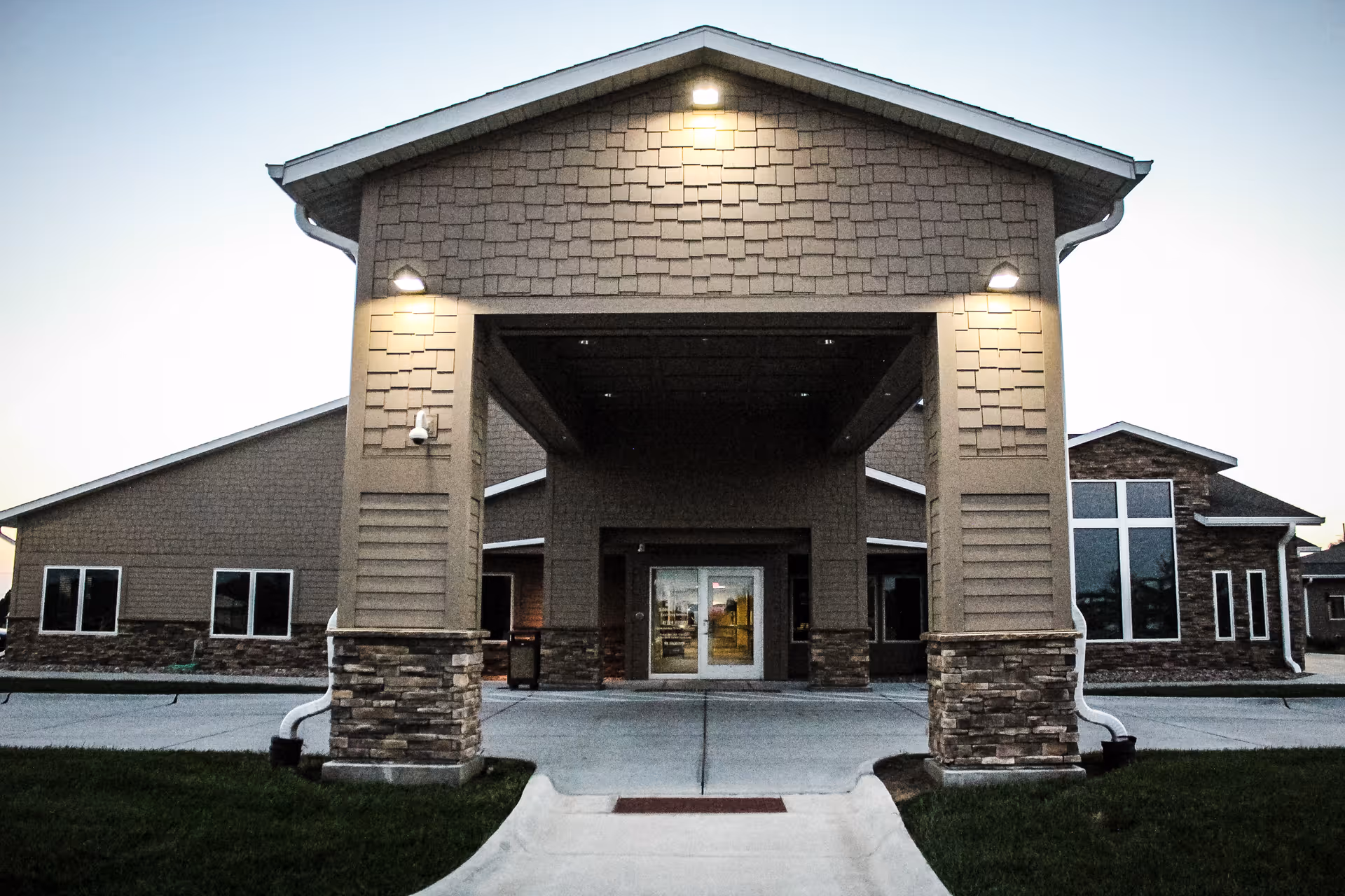 Front entrance of a modern Good Samaritan Society building with stone pillars.