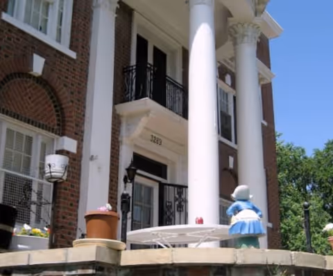 Front entrance of Heather Grove with brick exterior, large white columns, and planters.