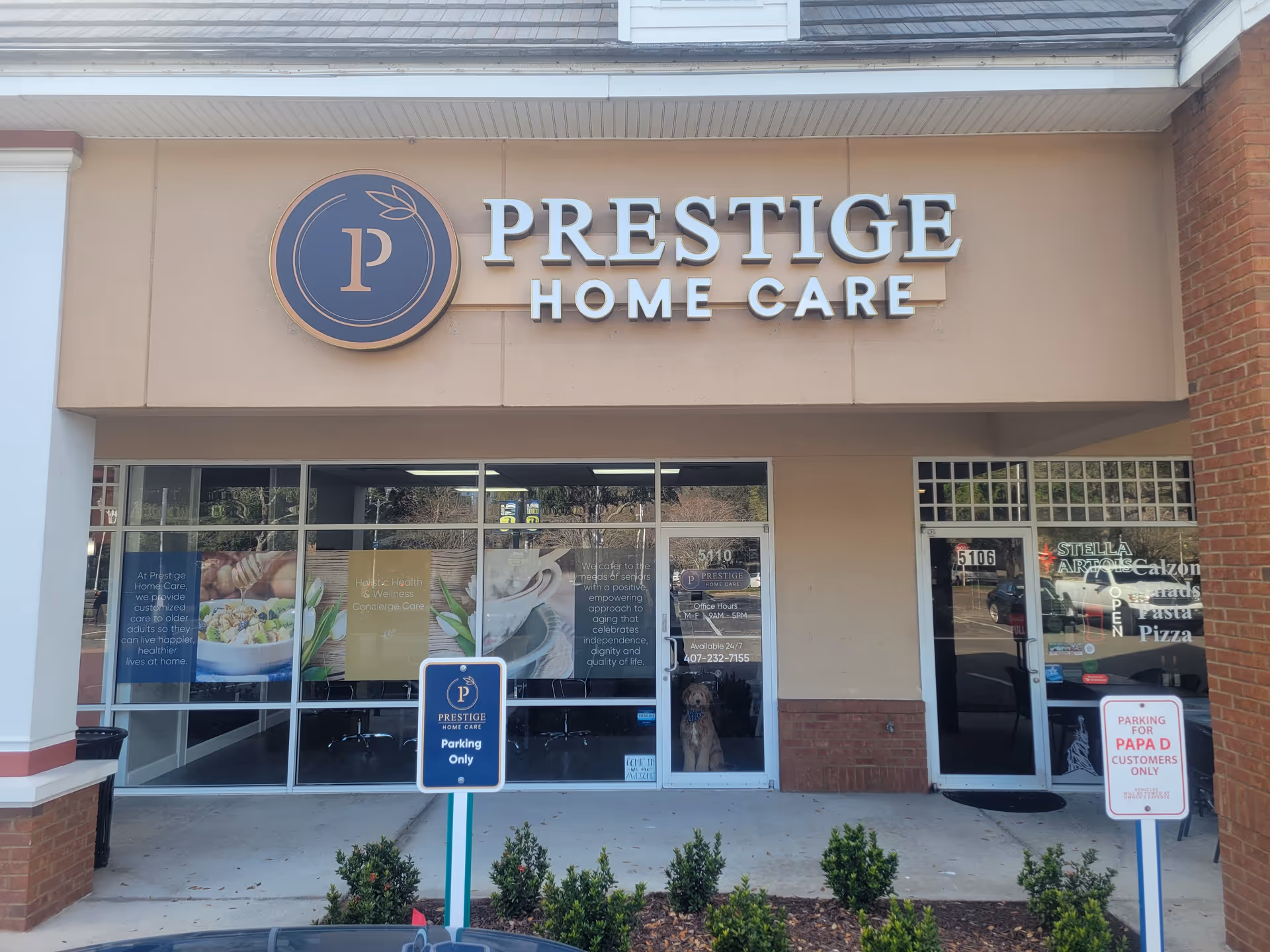 Front of a beige building with Prestige Home Care signage and glass doors.