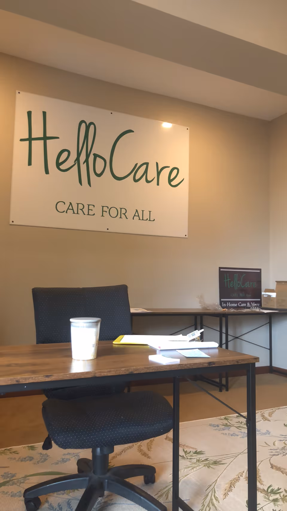 Reception desk area with HelloCare sign and office setup inside a senior care facility.