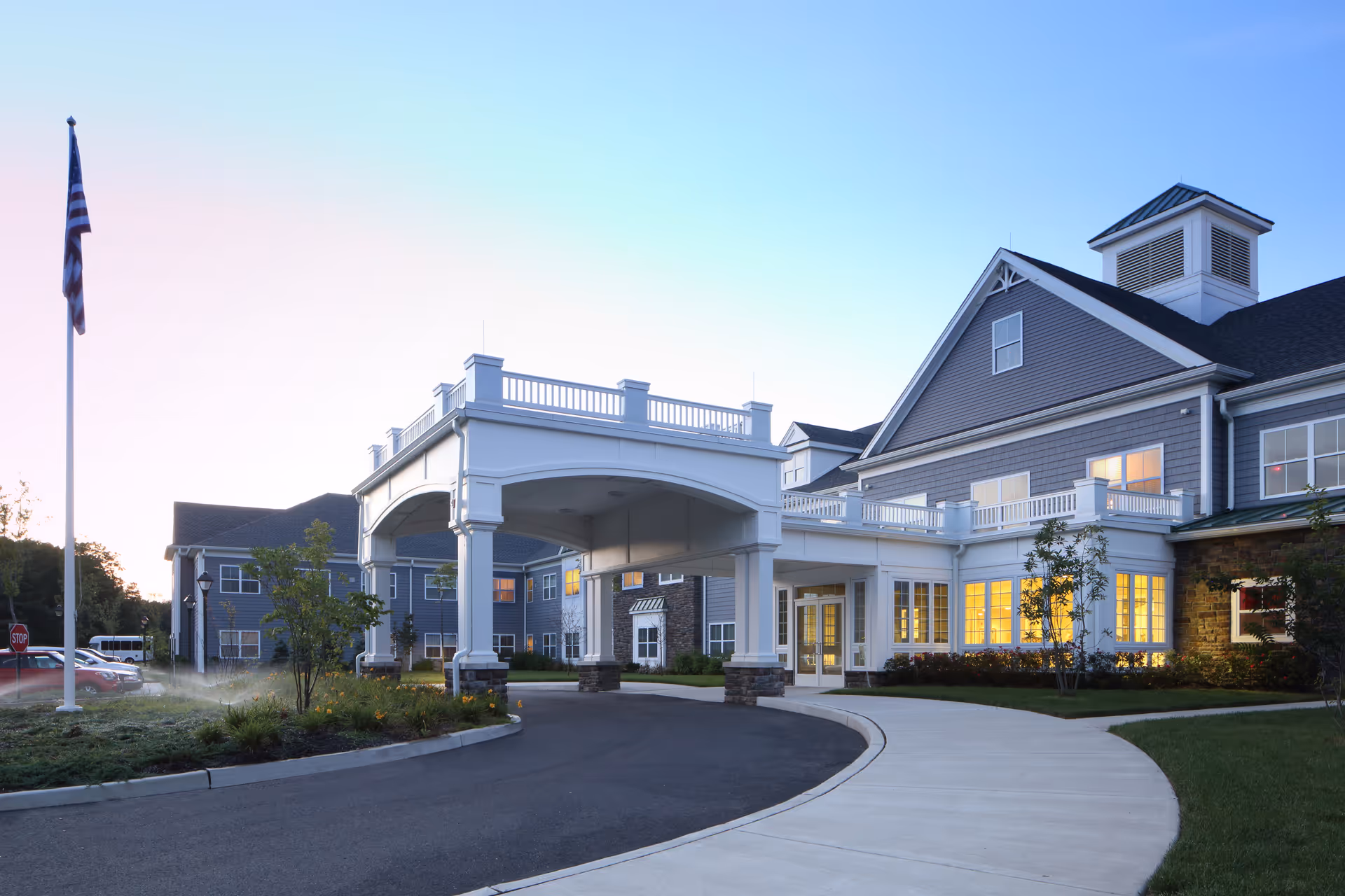 Exterior view of Sunnyside Manor featuring a covered entrance and curved driveway.