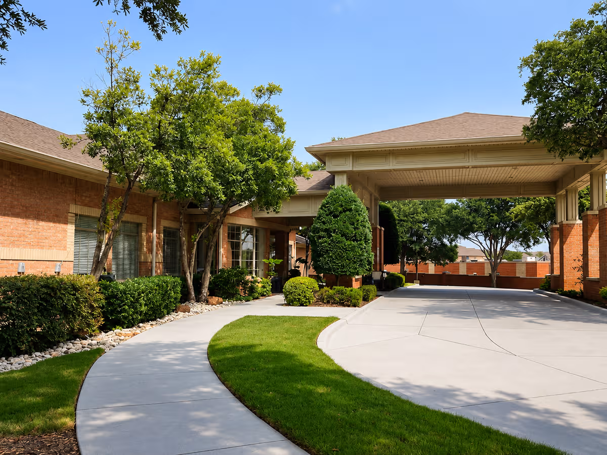 Exterior entrance of The Remington at Valley Ranch with a covered driveway.