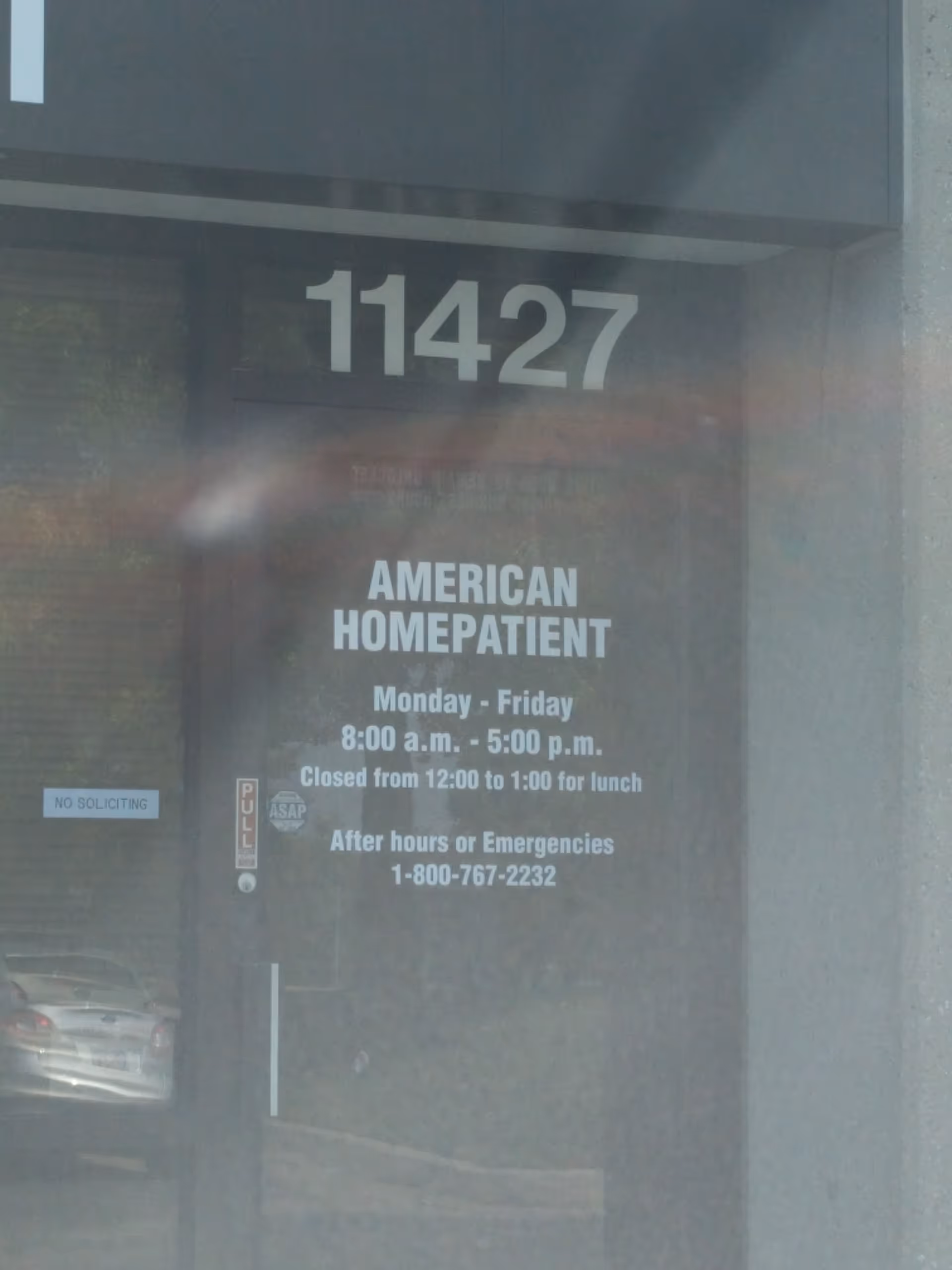 Glass entrance shows the number 11427 and American HomePatient signage.
