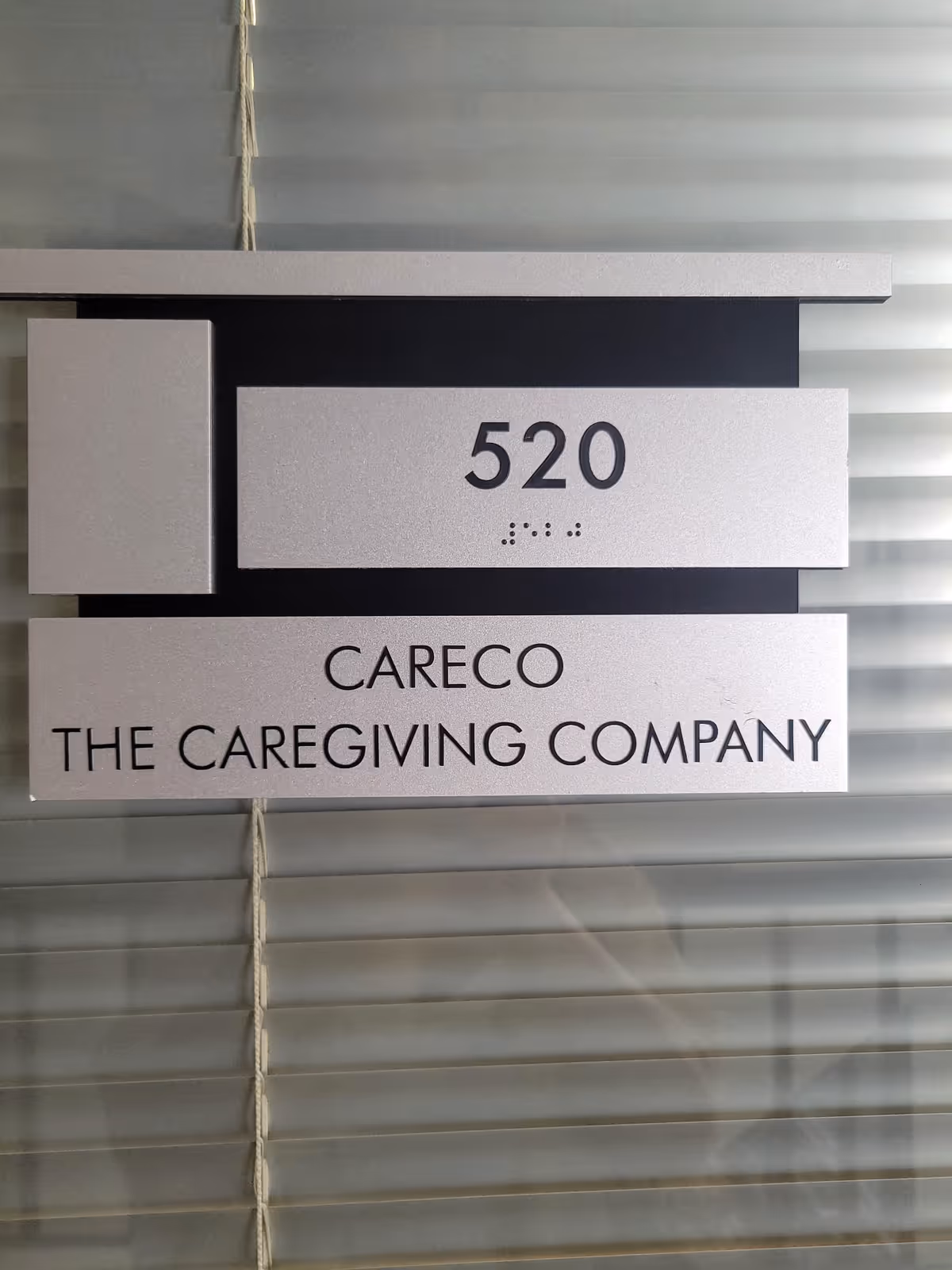 Close-up of a building sign displaying 520 and CareCo The Caregiving Company