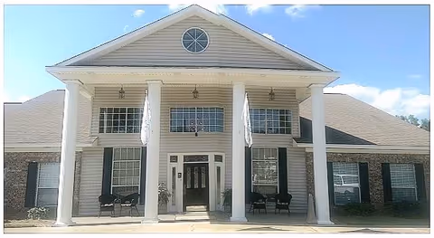 Front exterior of Davis Elderly Care building with tall columns and an entrance.