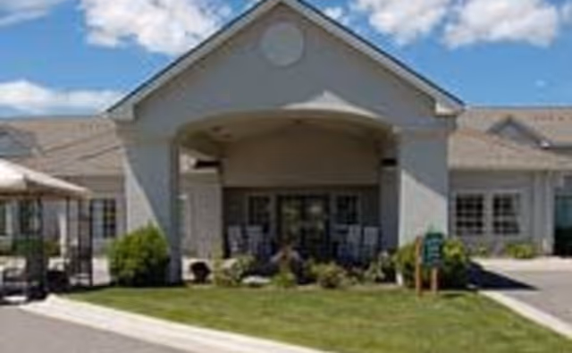 Front exterior of Bes House of Hope II senior living facility with covered entrance.