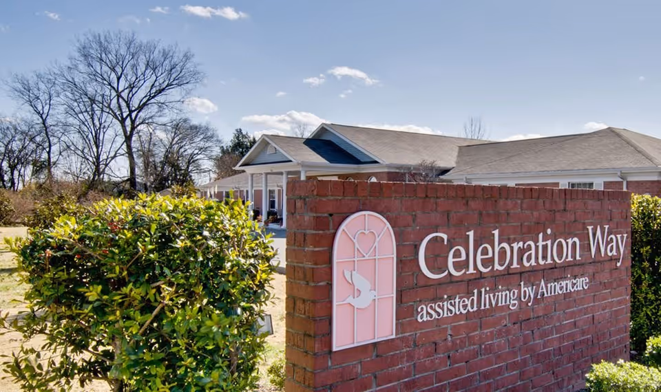 Brick sign reading Celebration Way assisted living sits before a single-story building.
