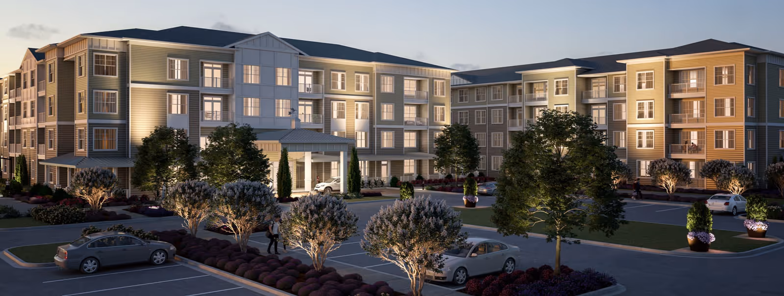 Exterior view of a multi-wing senior living facility with parking and landscaped grounds.