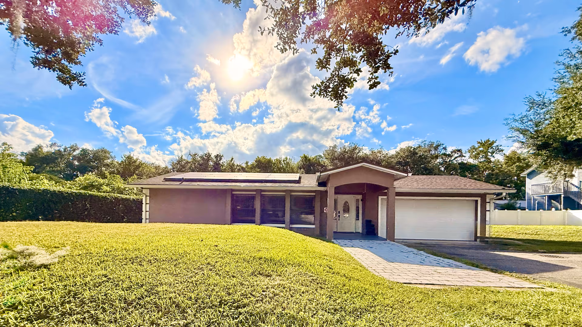 Single-story facility with a front lawn, driveway, and attached two-car garage.