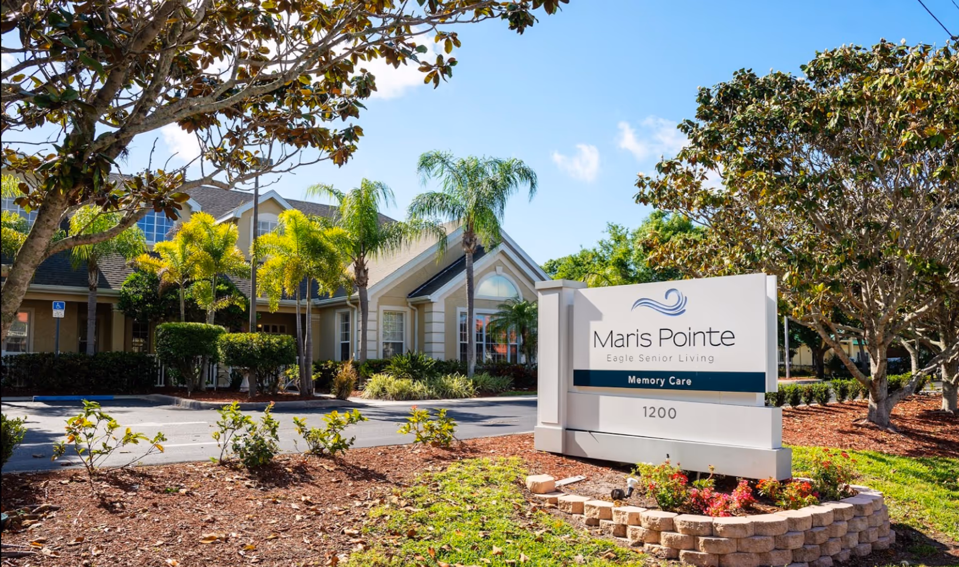 Exterior view of Maris Pointe senior living facility with sign and landscaping.
