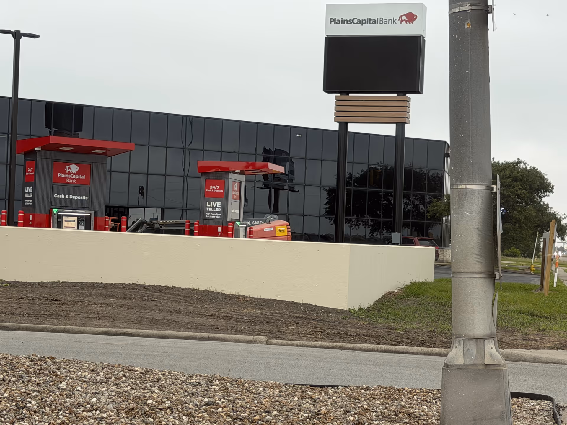 Exterior view of a PlainsCapital Bank branch with glass facade and signage.