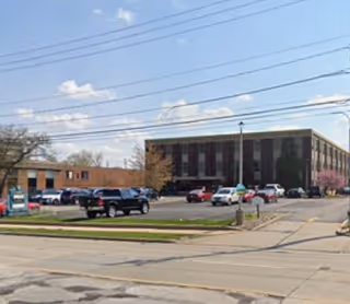 Exterior view of Pearl's Hope Home Health Care building with parked cars.