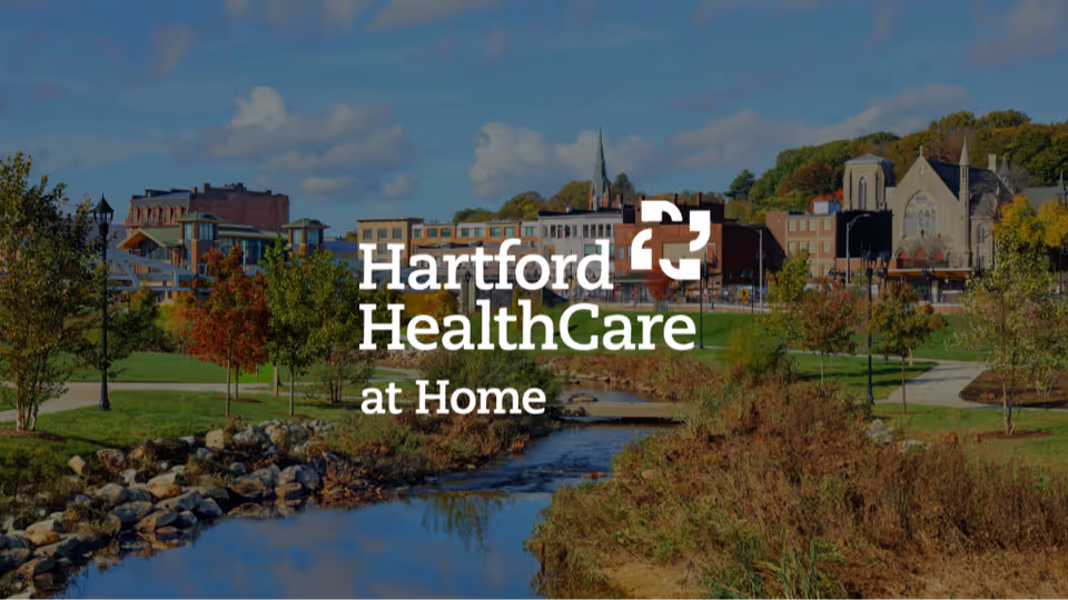 Exterior view of Hartford HealthCare at Home campus with river and trees