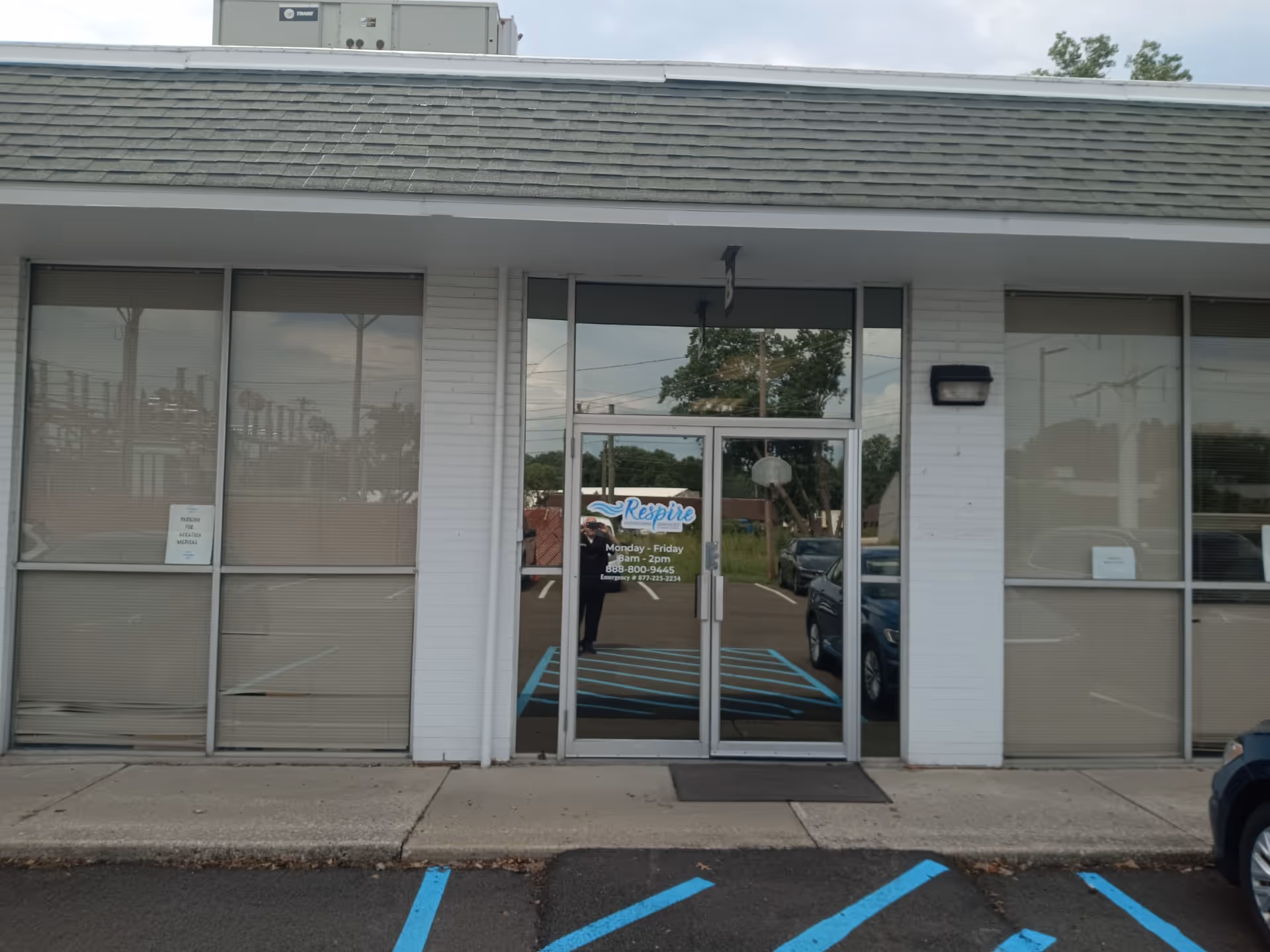 Facade of Respire Homecare Services Toledo with glass entrance doors and large windows.