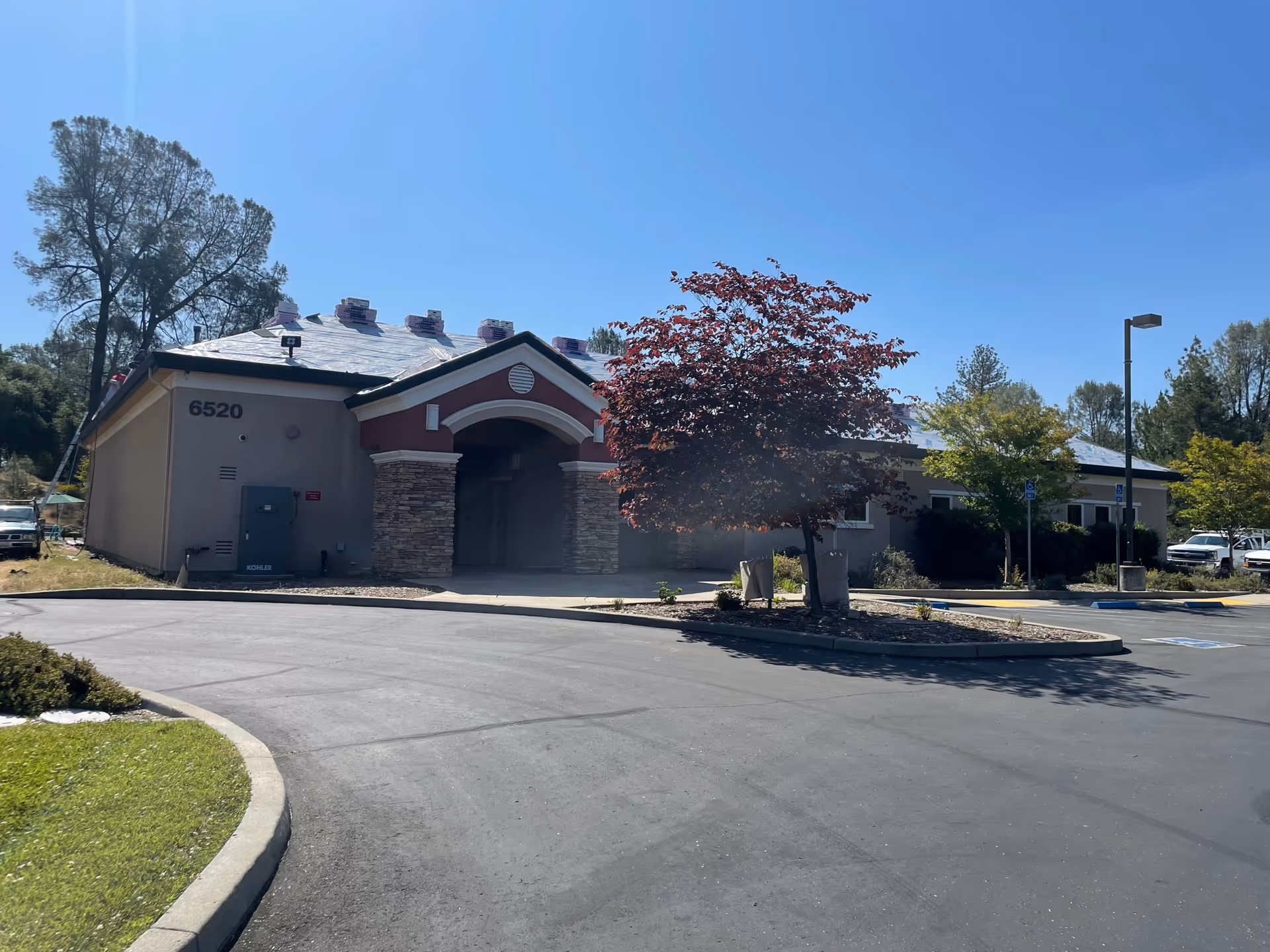 Single-story medical office building with arched entrance and surrounding parking lot.