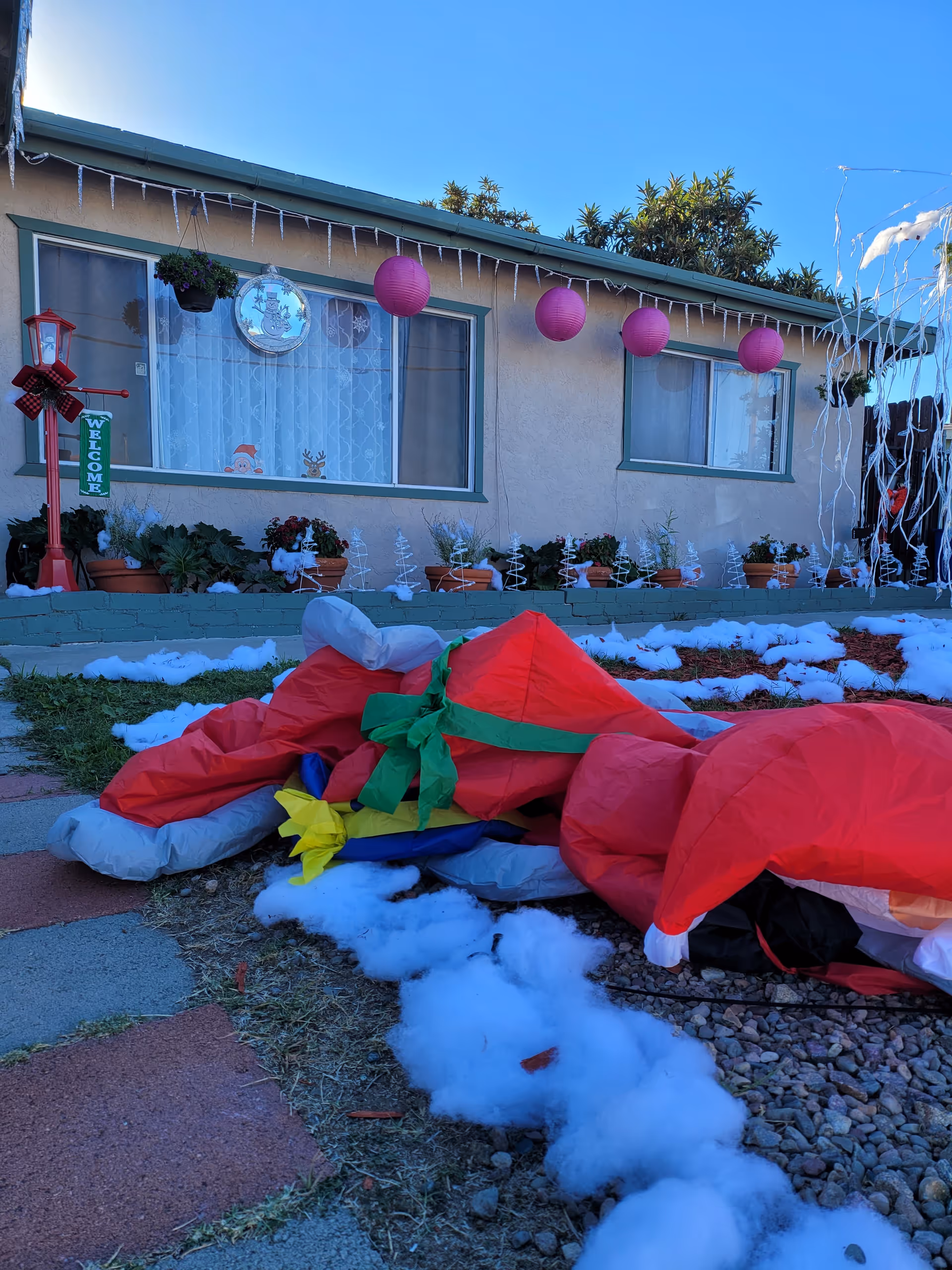 Front of Morningside Manor with holiday decorations and a pile of red inflatables outside.