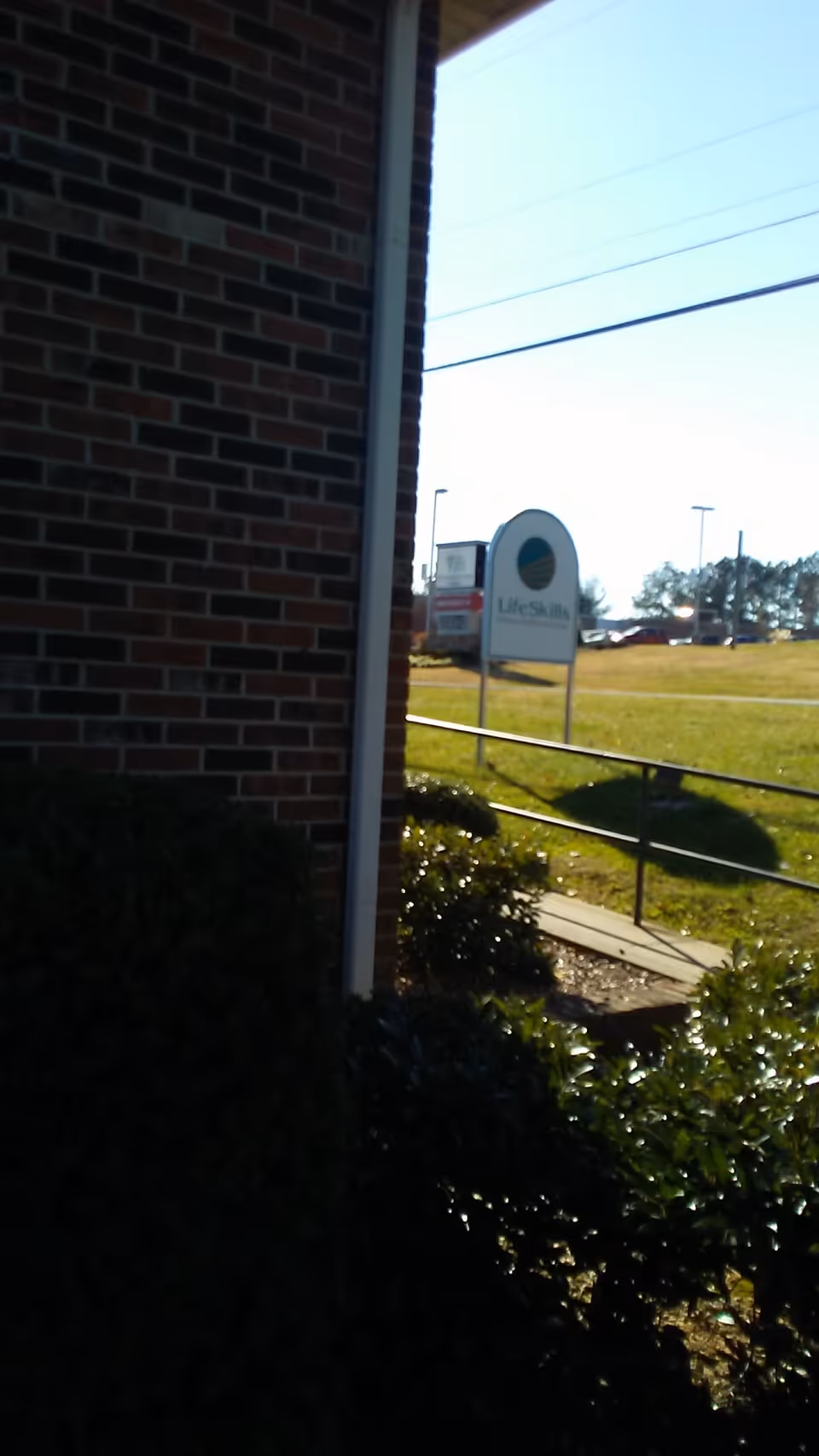Exterior view of Lifeline Health Care of Simpson with a LifeSkills sign by the road
