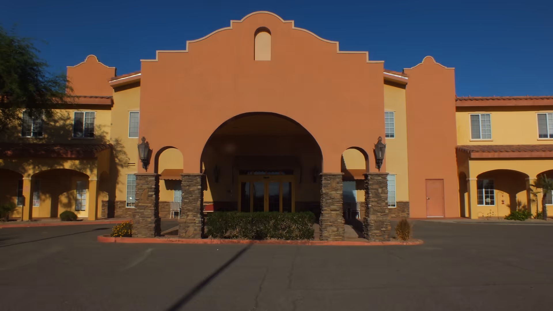 Front view of Pennington Gardens senior living facility with an arched entrance.