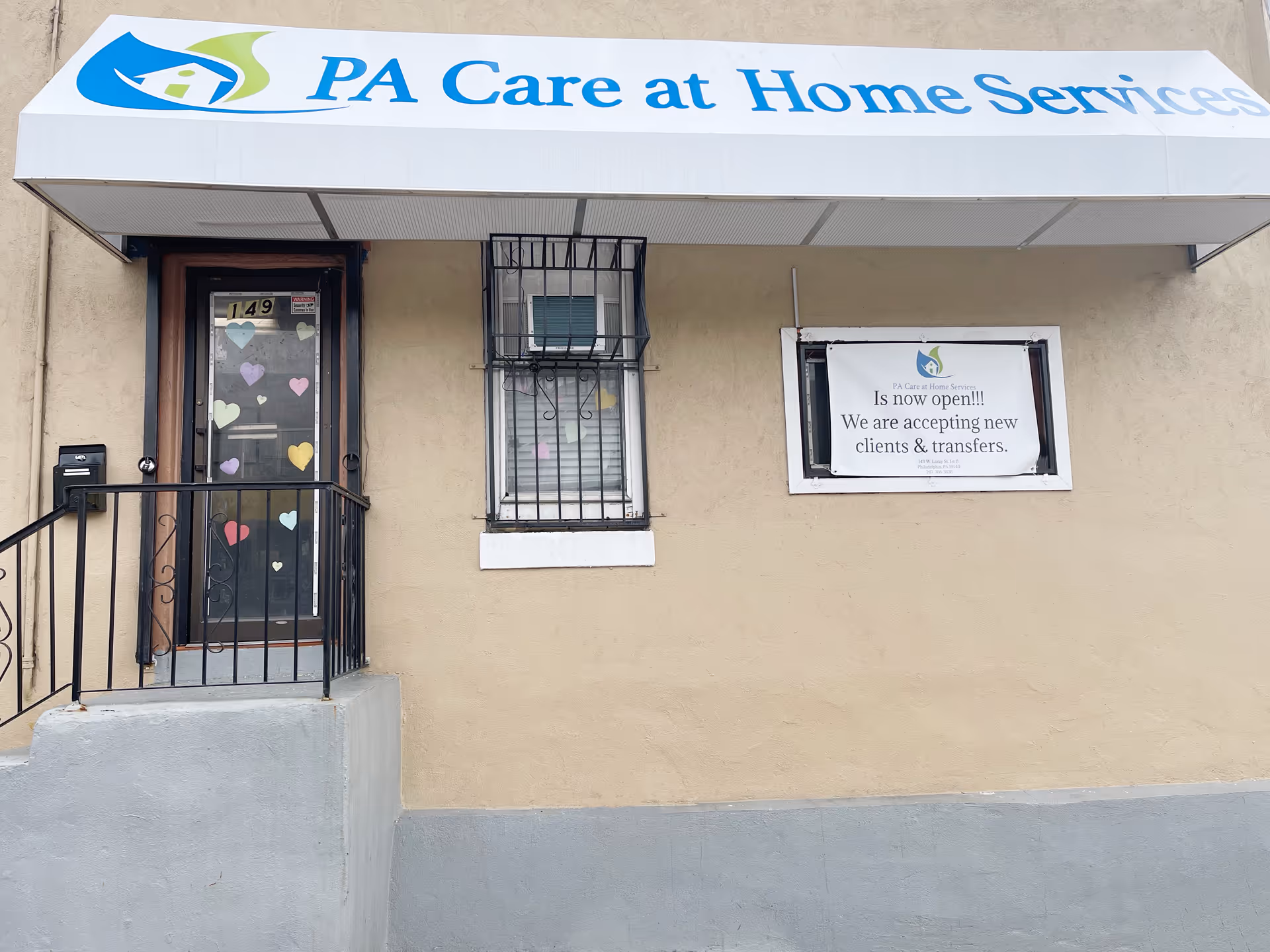 Front exterior of PA Care at Home Services with awning sign and heart-decorated entrance.