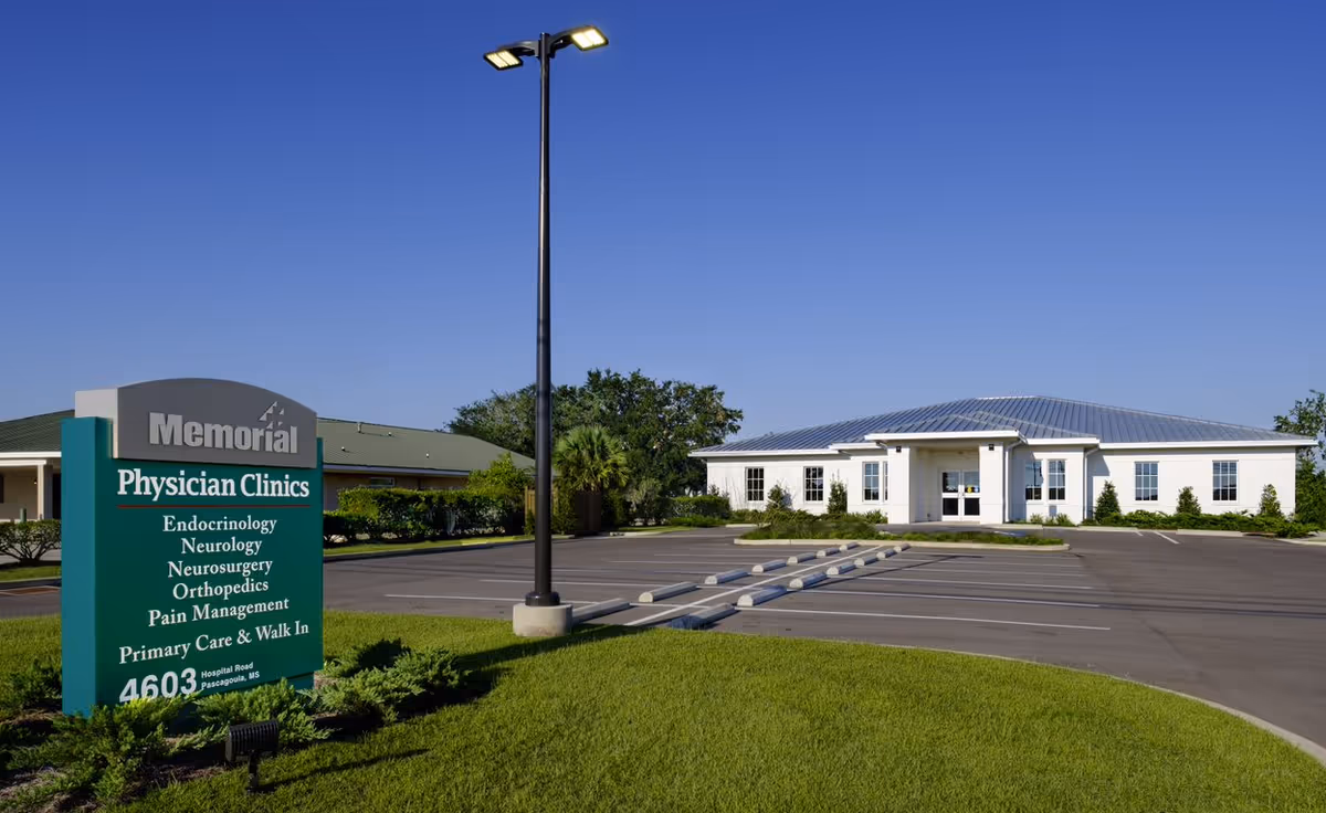 Exterior view of Memorial Physician Clinics Pascagoula facility front with sign and parking.