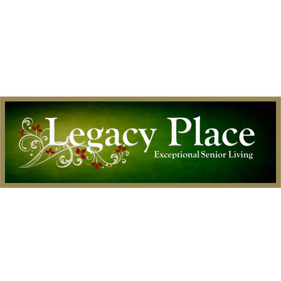 Green sign reading Legacy Place with decorative white floral designs.