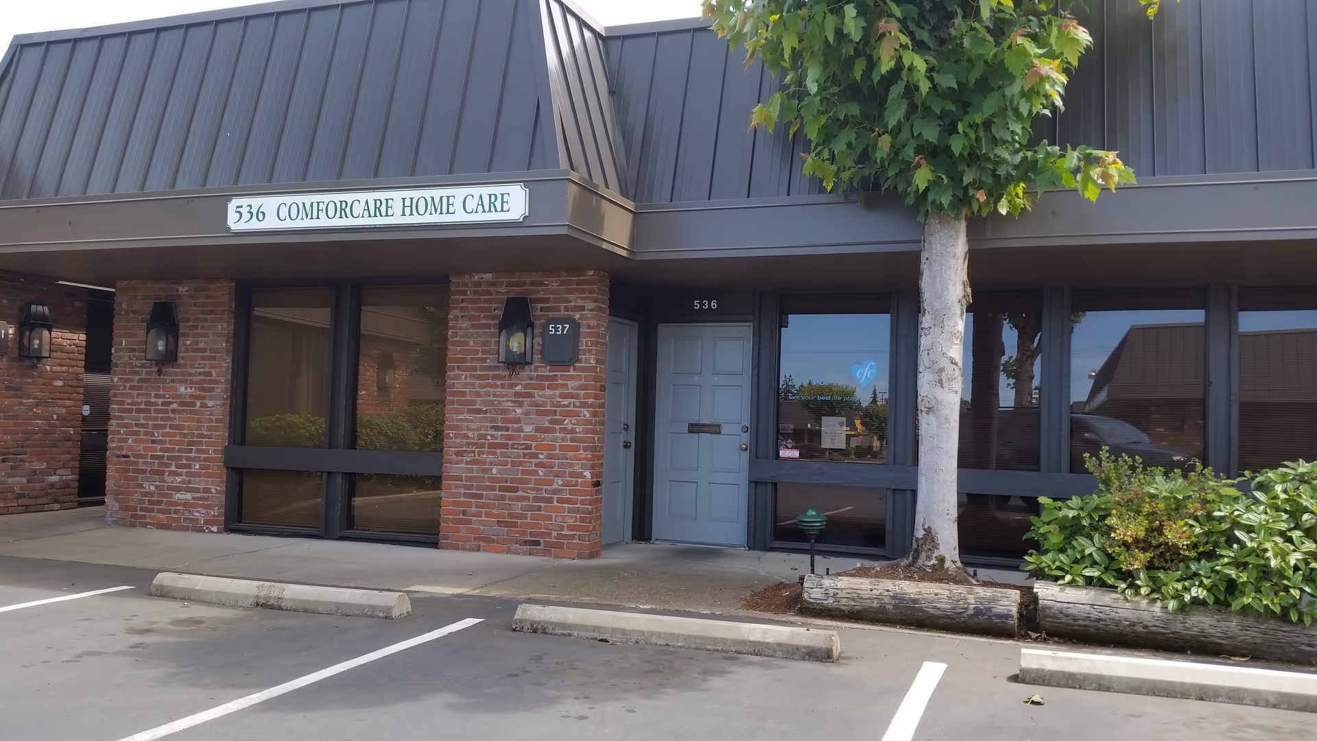 Front view of a ComForcare Home Care building with brick exterior and entrance.