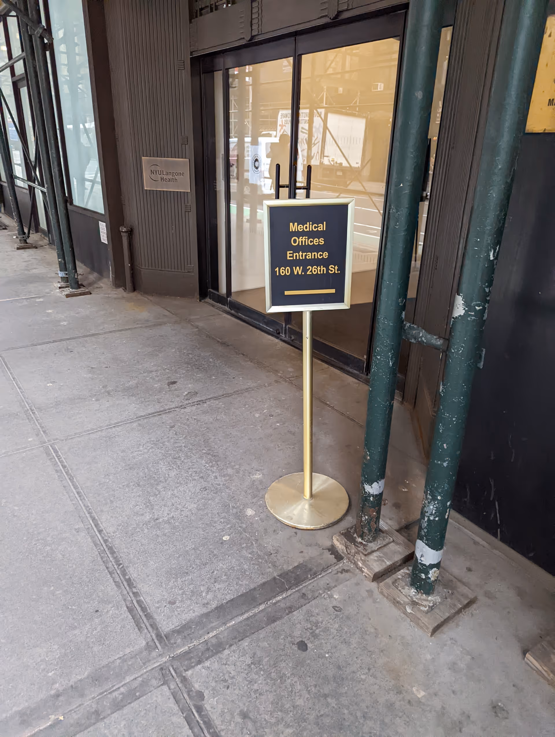 Exterior entrance of NYU Langone Ambulatory Care Chelsea with a standing sign.