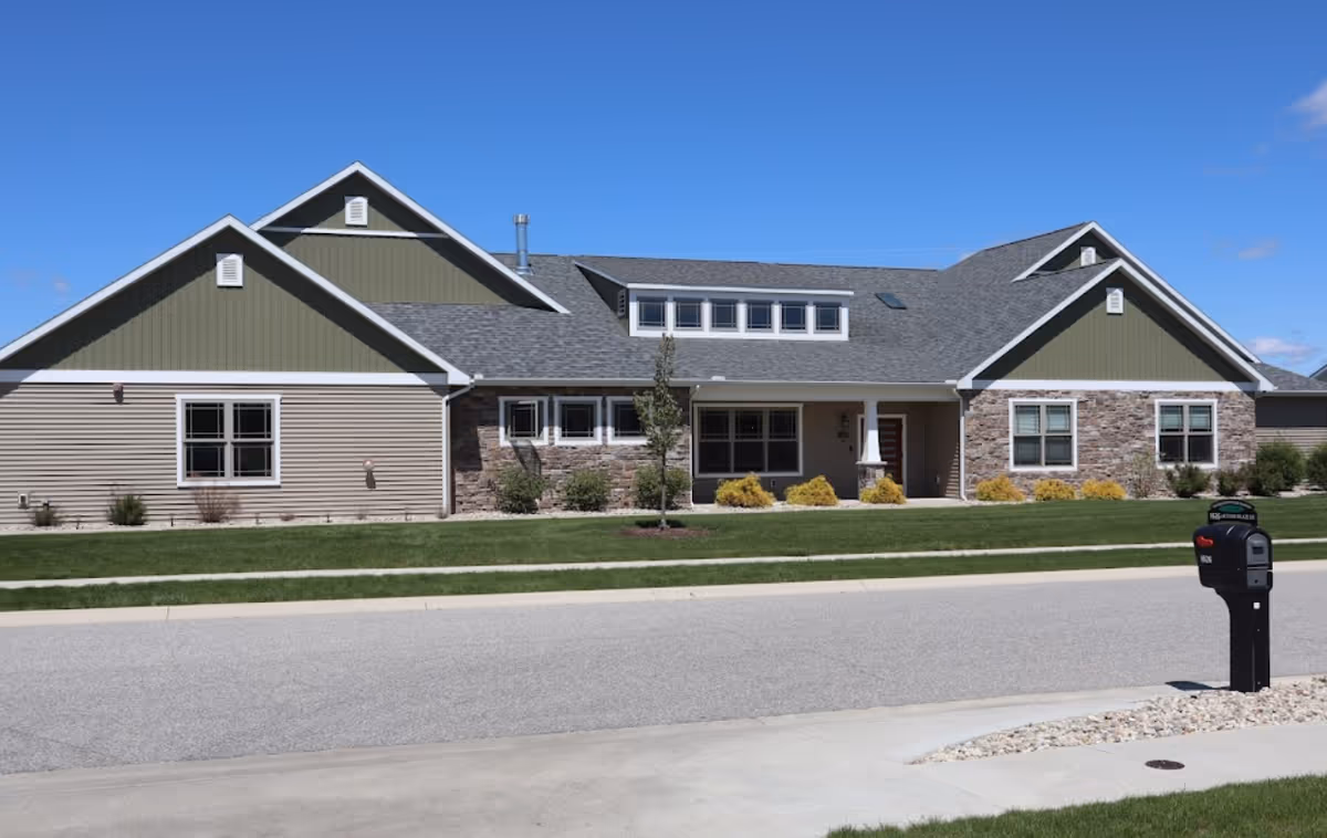 Front view of The Laurels of Goshen: facility with green accents and stone facade.