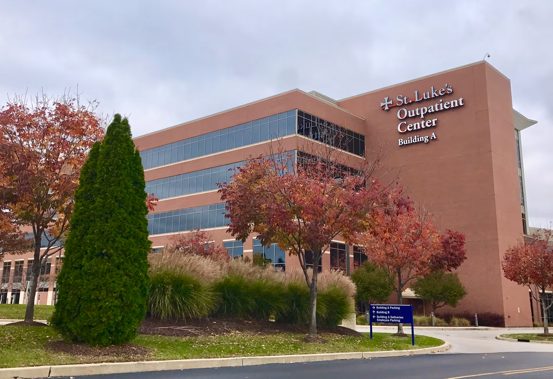 Exterior view of St. Luke's Outpatient Center building with trees and landscaping.