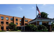 Exterior view of Markley Rehabilitation and Healthcare Center, a brick building with flagpole and landscaping.
