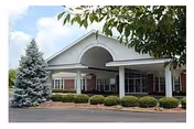 Front view of Wellington Parc of Owensboro senior living entrance with arches and landscaping.