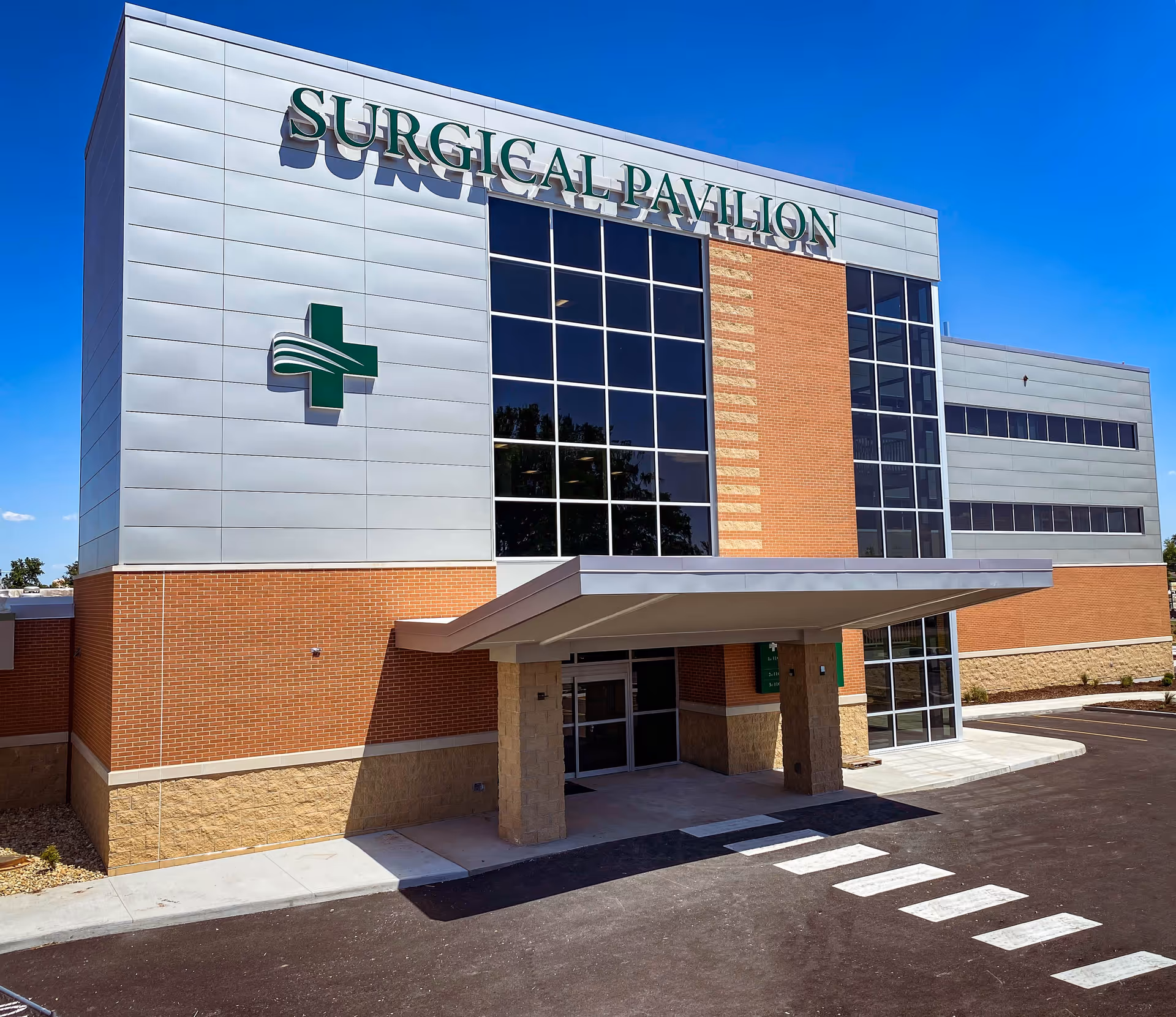 Exterior view of a medical facility with Surgical Pavilion sign and brick facade.