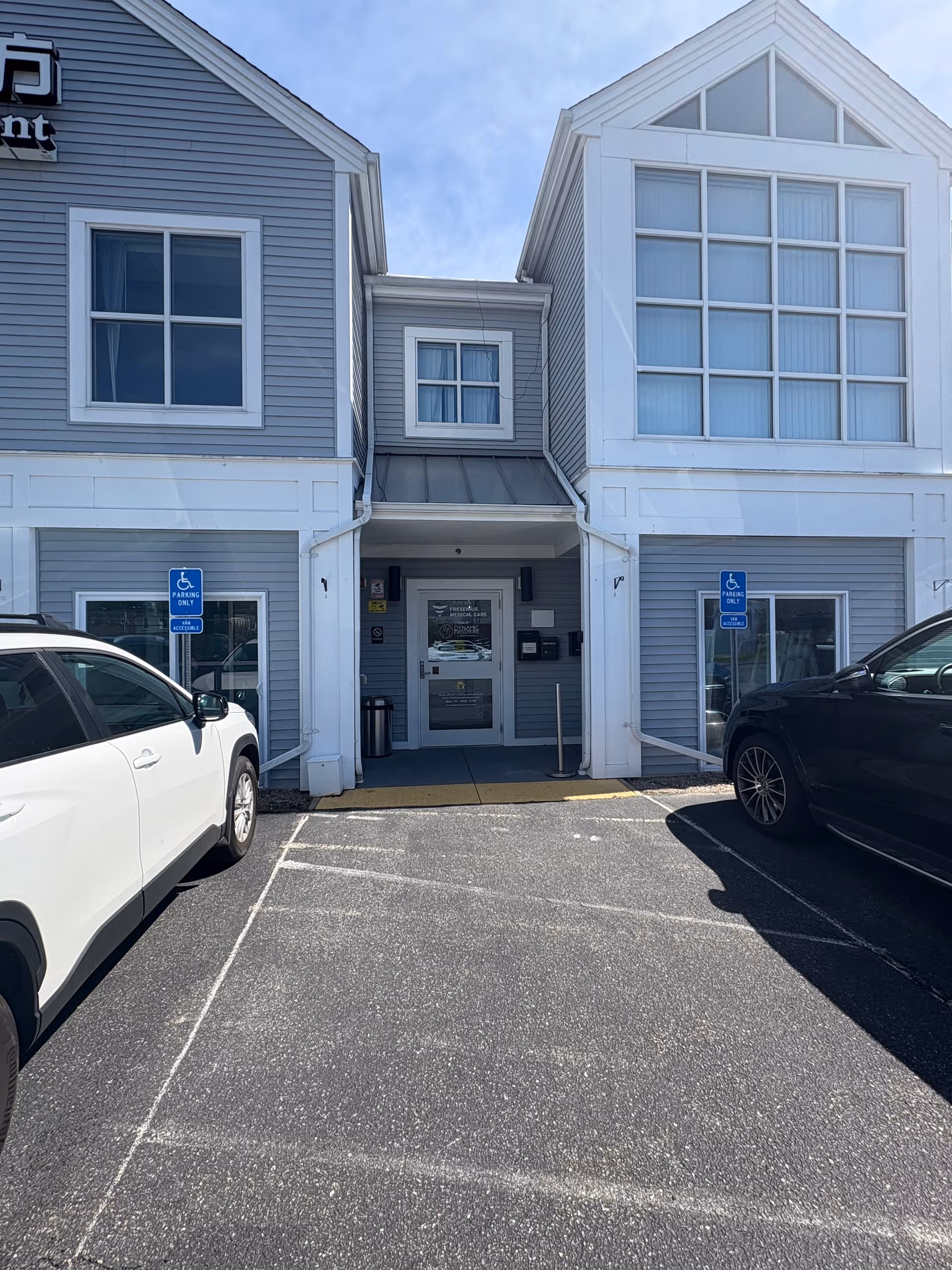 Front view of MassBay Home Care, Inc. building with glass entrance and parking.