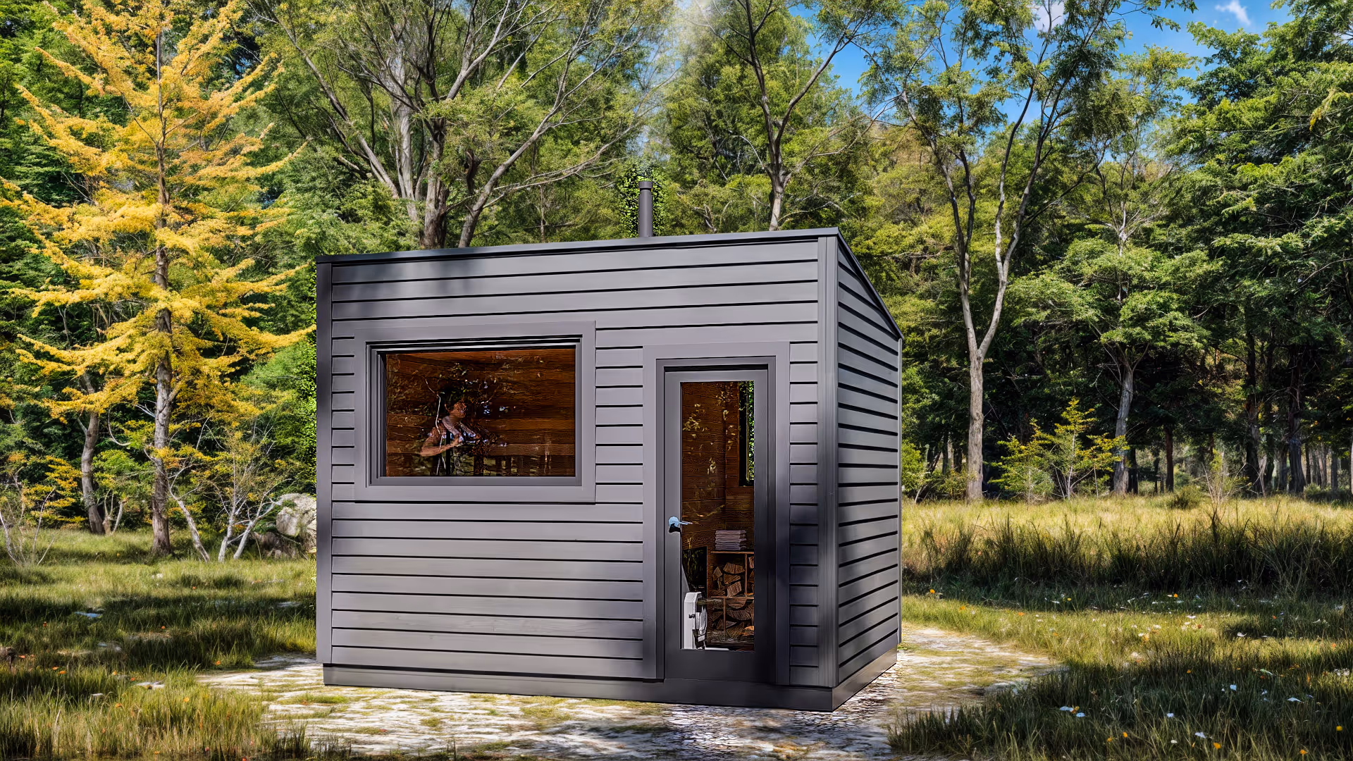 Small modern sauna hut sits outdoors in a grassy, wooded clearing.