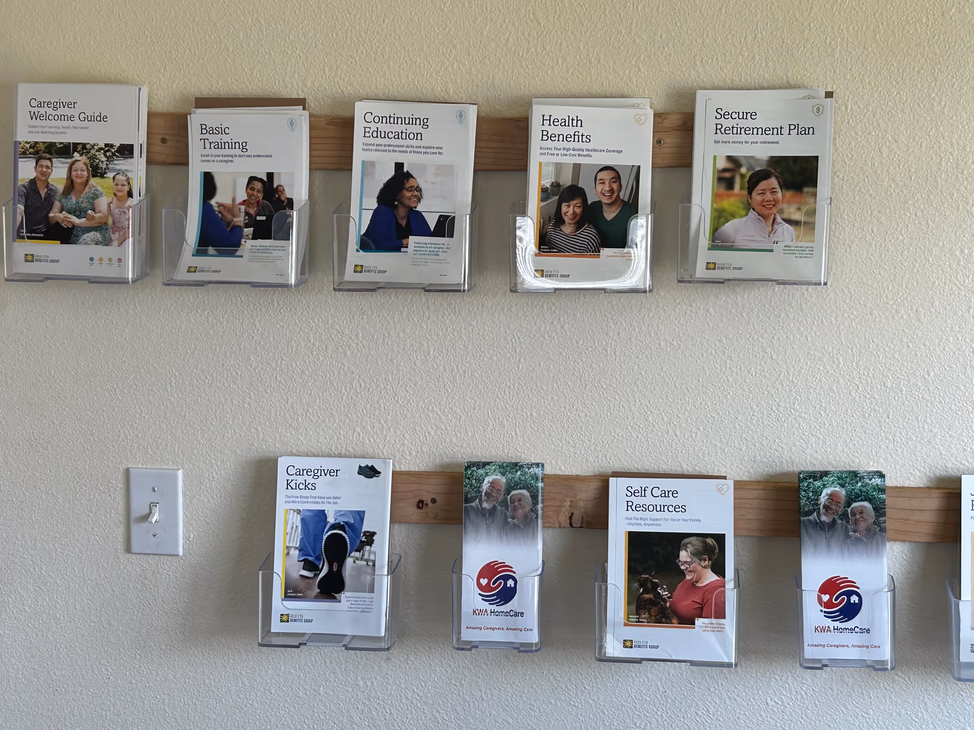 Interior wall with brochure racks displaying caregiver guides and resources for KWA.