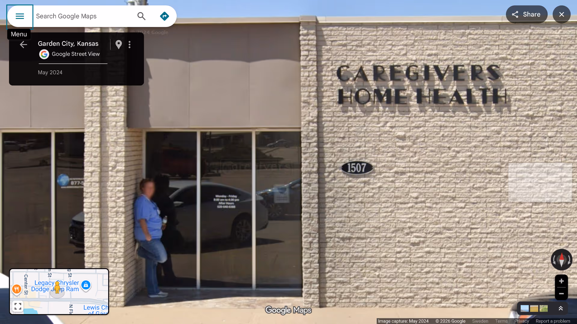 Exterior view of Caregivers Home Health building entrance with glass doors and two people outside.