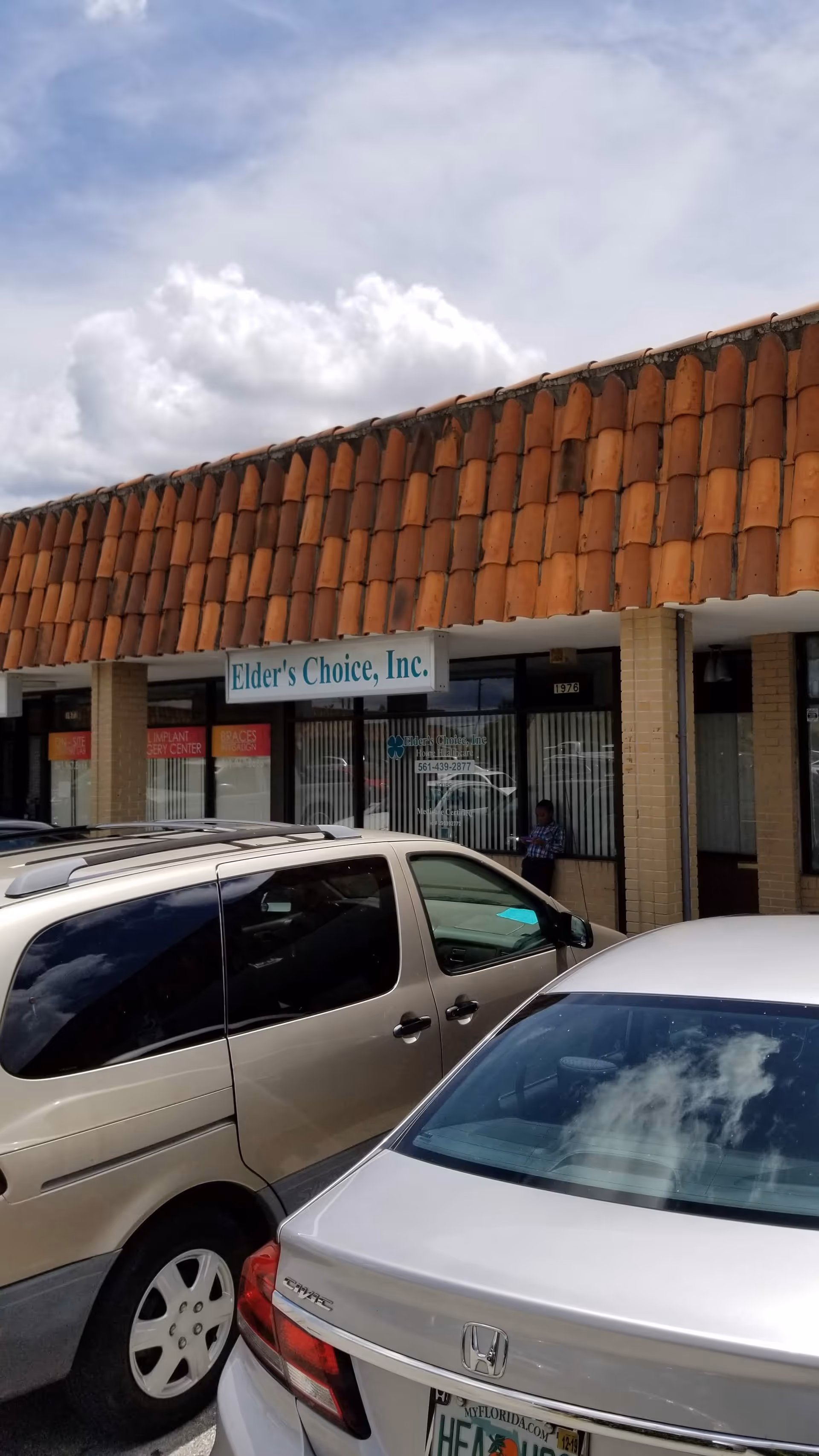 Exterior view of Elder's Choice, Inc. storefront with tiled roof and parked cars.