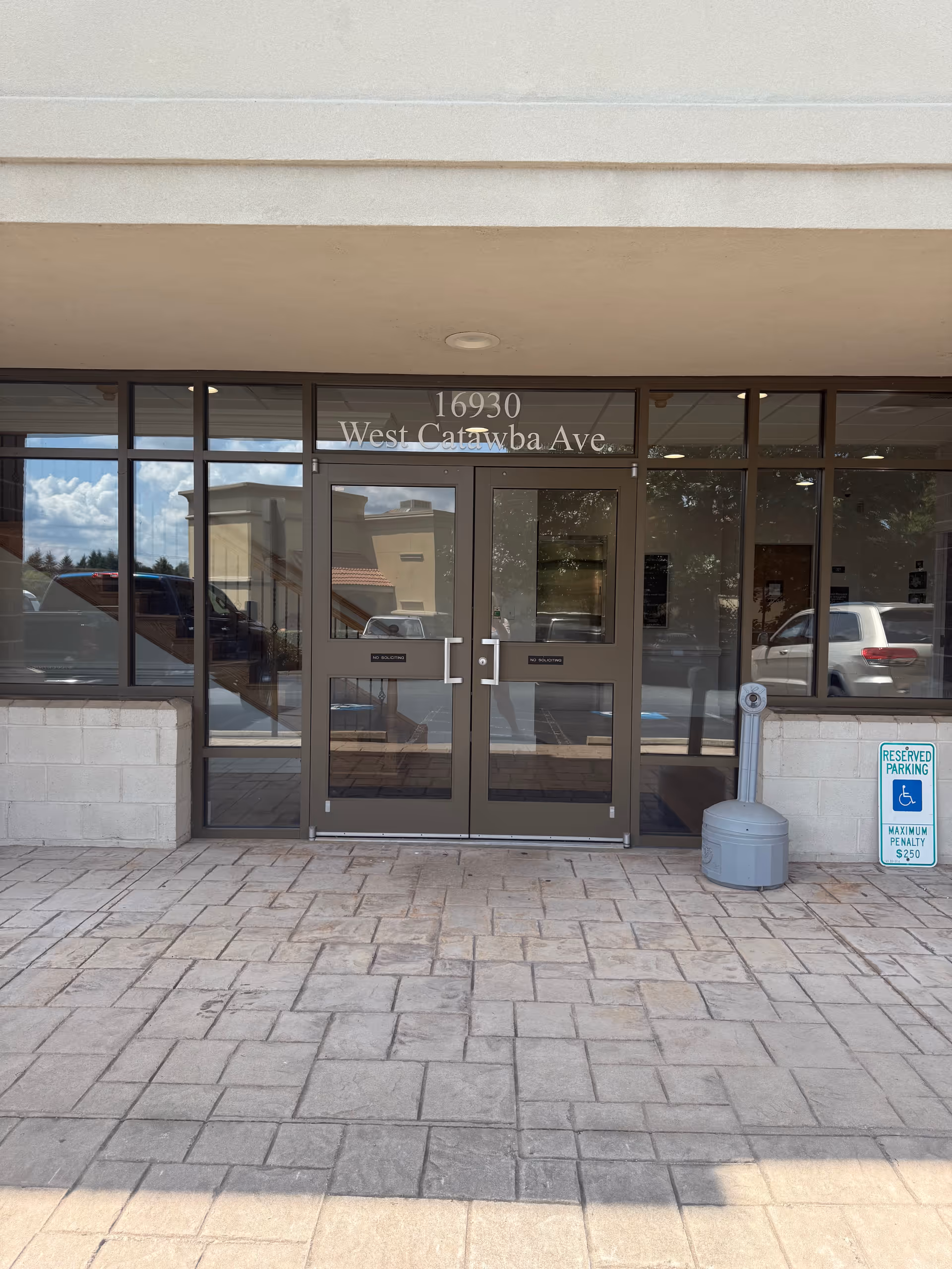 Glass entrance doors with address 16930 West Catawba Ave in front of a senior services building.