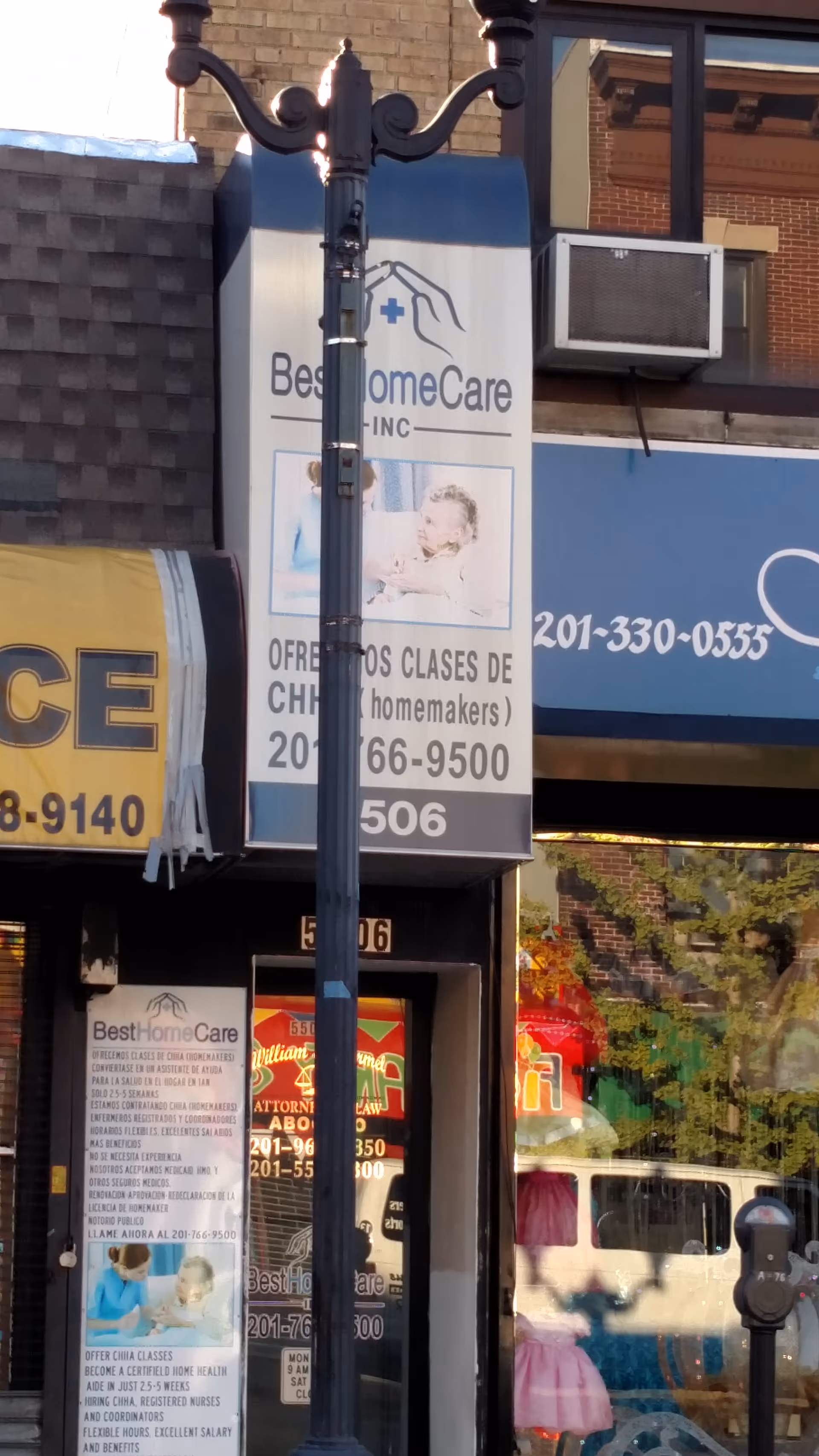 Storefront signage for Best Home Care Inc on a city street, with a lamppost nearby.